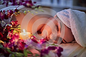 Woman lies on couch with flowers lit by burning photo