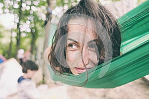 The woman lies in a hammock.