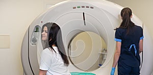 A woman lies on the tomograph table. woman is undergoing computed axial tomography examination in a modern hospital