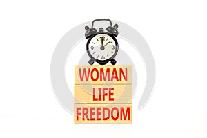 Woman life freedom symbol. Concept words Woman Life Freedom on wooden blocks on a beautiful white table white background. Black