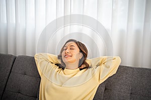 woman lifestyle relaxing sleeping on sofa living room and smiling, waking up in the morning and drowsy during the day