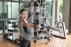 Woman lift dumbbell weight training in gym