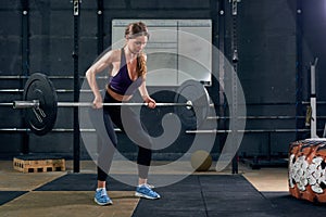 Woman Lifting Barbell in Gym