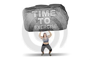 Woman lifts stone with time to exercise word