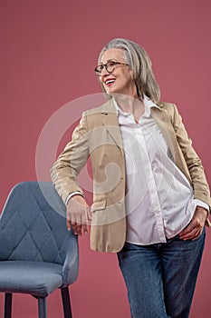 Woman in light jacket standing and looking confident