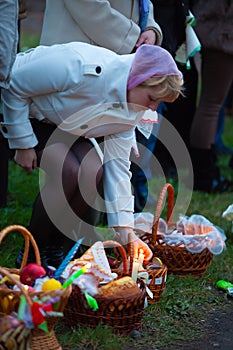 Woman lighting a candle in an Easter basket
