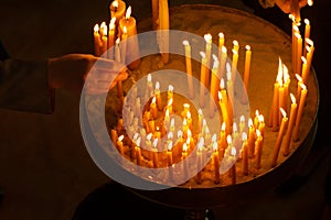 Woman lighting candles in a church