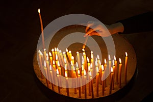 Woman lighting candles in a church