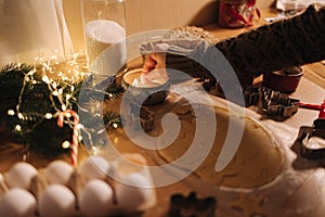 Woman lights a candle on Christmas. Preparing for baking gingerbread. Christmas mood