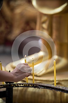 Woman Lights Candle at Doi Suthep Temple