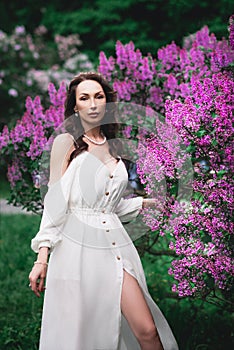 Fashion model, woman in lilac purple garden. Luxury fragrance concept