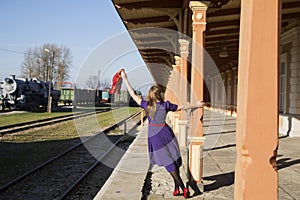 Woman in lilac dress with reddish scarf