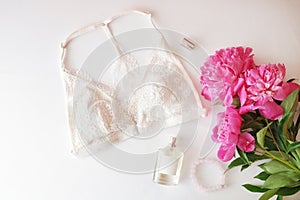 Woman lingerie with accessories and flowers collage on white, flat lay, top view.