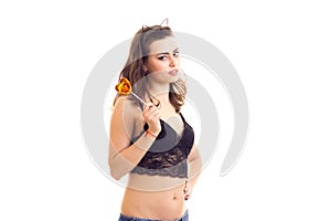 Woman in lingerie and denim shorts with candy