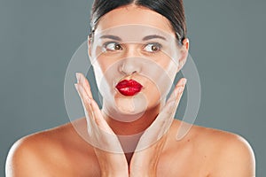 Woman lips with lipstick, kiss face and makeup with red cosmetics and playful pout isolated on studio background