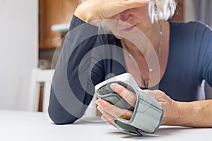 Woman lis looking at the results of blood pressure