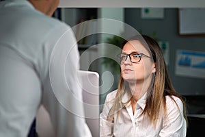 Woman listening intensely to man at work, stress