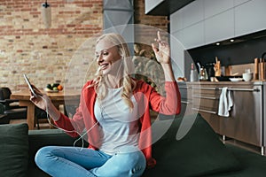 Woman listening music in earphones while