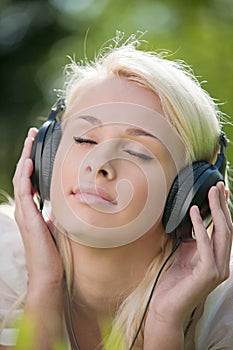 Woman listening music in headphones