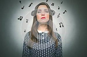 Woman listening music via headphones.