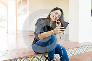 Woman Listening Radio Broadcast Via Mobile Application At Entrance