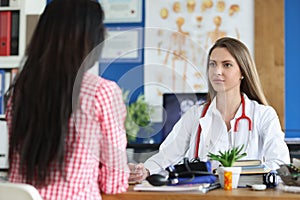 Woman is listening to general practitioner or gynecologist in clinic office