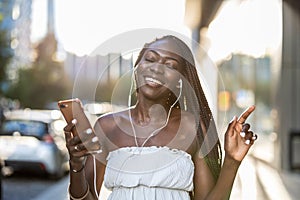 Woman listening to music with earphones in the city