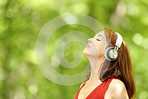 Woman listening to music with headphones breathing