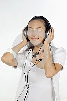 Woman listening to music on headphones. Conceptual image