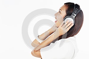 Woman listening to music on headphones. Conceptual image