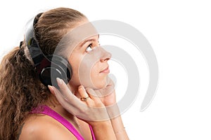 Woman listening to music in headphones looking at blank copyspace