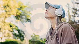 Woman listening to music with headphones in the nature