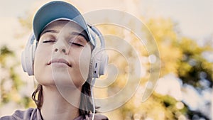 Woman listening to music with headphones in the nature