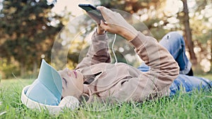 Woman listening to music with headphones in the nature