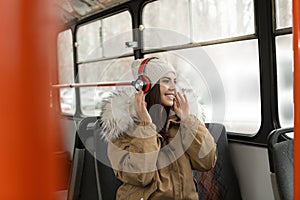 Woman listening to music with headphones in public transport