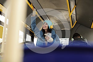 Woman listening to music with headphones in public transport