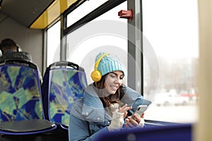 Woman listening to music with headphones in public transport