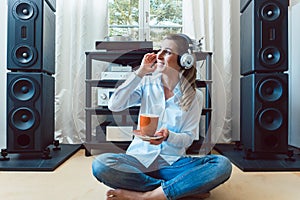 Woman listening to music from a Hi-Fi stereo