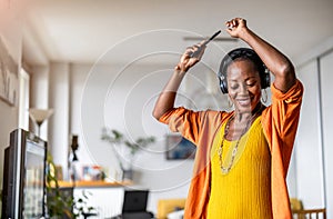 Woman listening to music in the living room at home