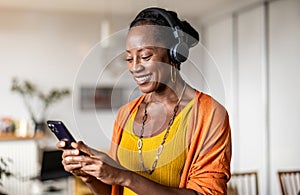 Woman listening to music in the living room at home