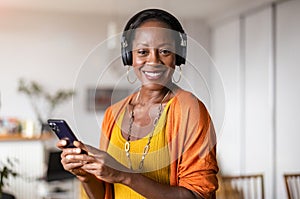 Woman listening to music in the living room at home