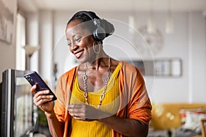 Woman listening to music in the living room at home