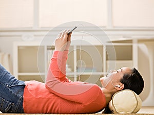 Woman listening to music on mp3 player