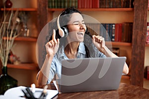 Woman listening to music online in headphones
