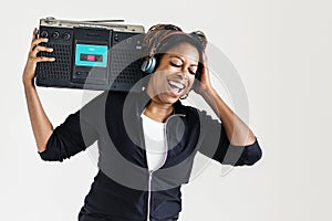 A woman listening to the music from a radio photo