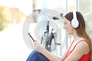 Woman listening to the music from a tablet in a park