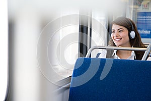 Woman listening to music on train
