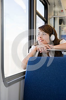 Woman listening to music on train