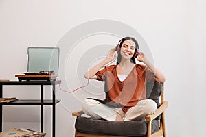 Woman listening to music with turntable