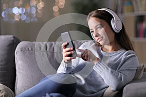 Woman listening to music using headphones and phone